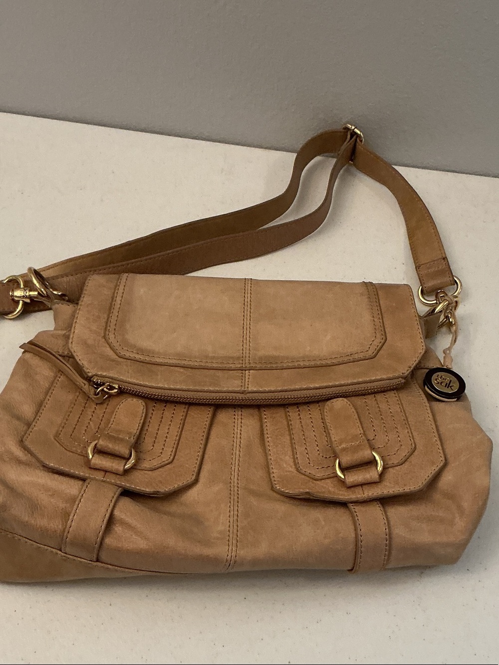 The Sak Tan Shoulder Bag with Front Buckle Pockets